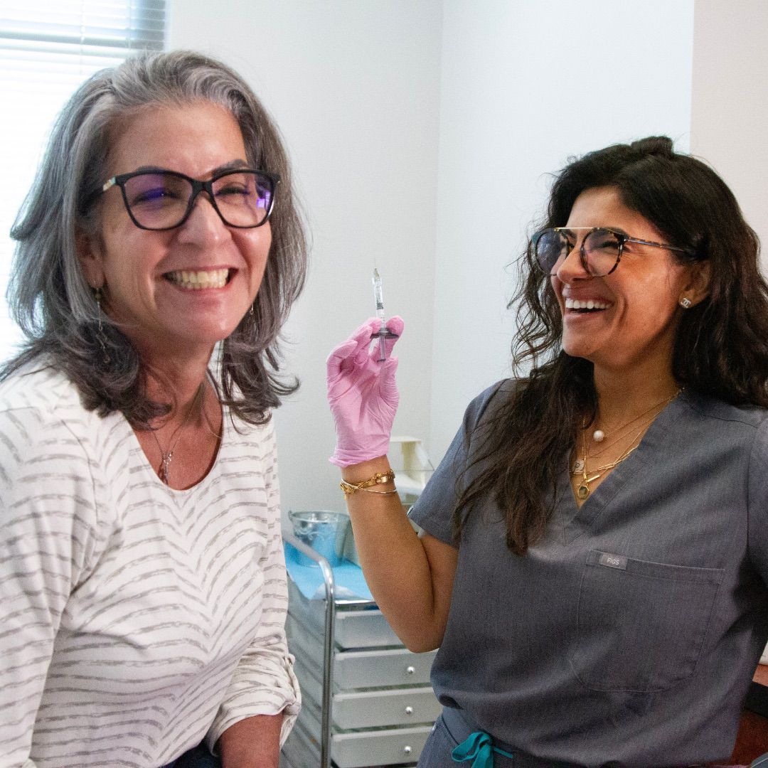 A member of the Stadia injector team smiling with a client
